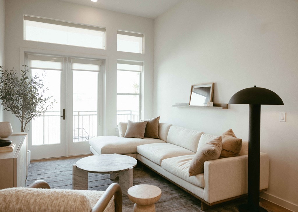 a living room with a white couch and a table