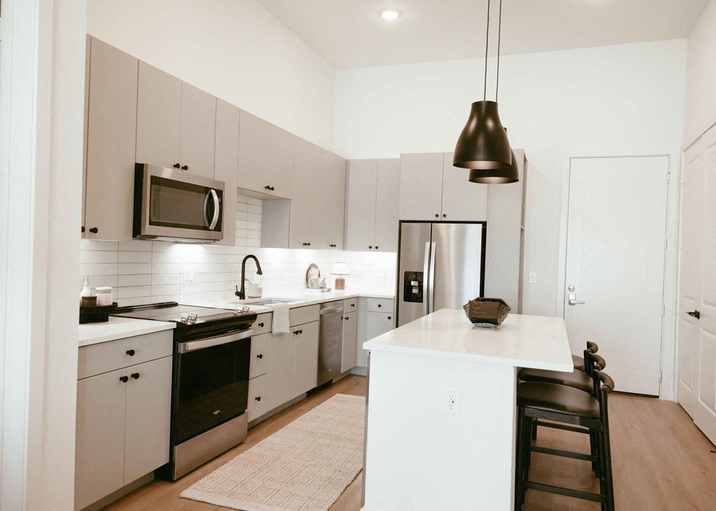 a kitchen with white cabinets and a white counter top