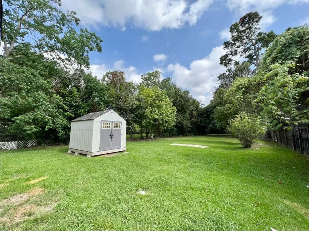 a small shed in the middle of a field
