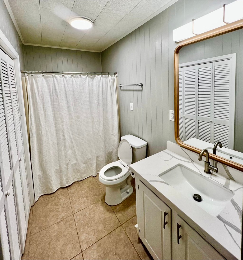 a bathroom with a toilet and a sink and a shower