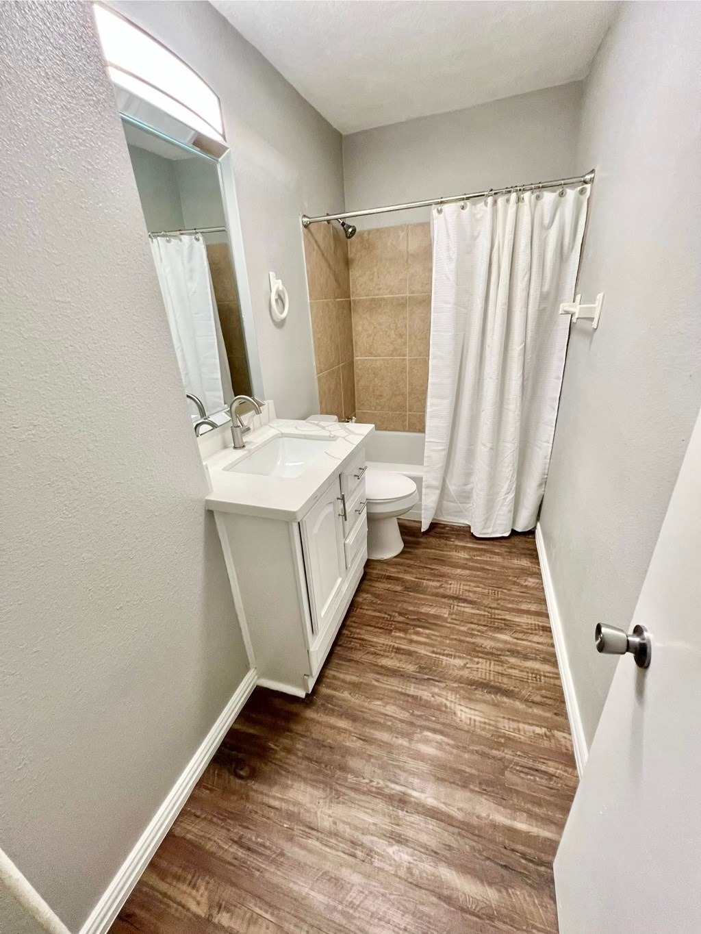a bathroom with a sink and a toilet and a shower
