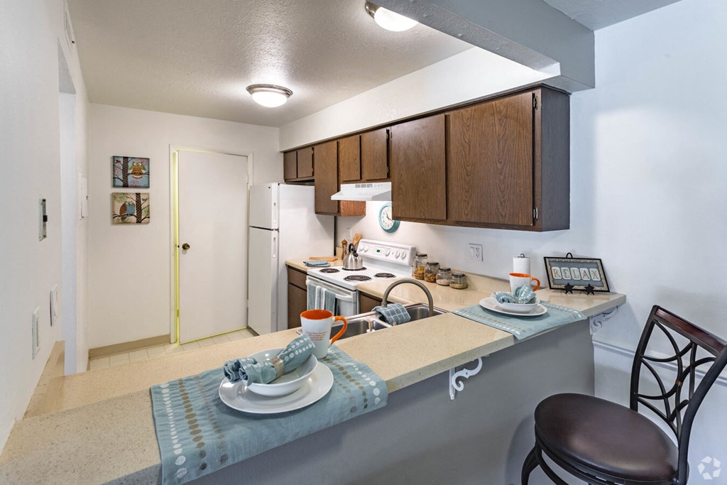 a kitchen with a counter top and a sink and a refrigerator