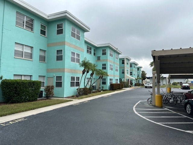 a row of turquoise apartment buildings on the side of a street