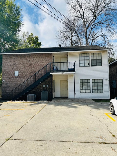 a white building with a staircase on the side of it