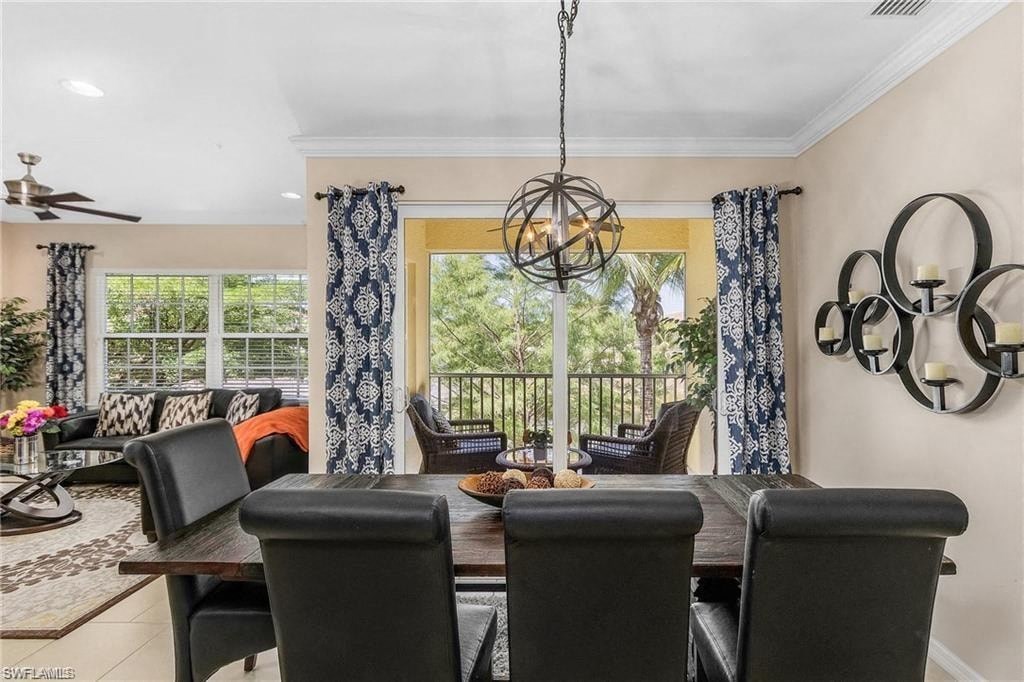a dining room with a table and chairs and a balcony