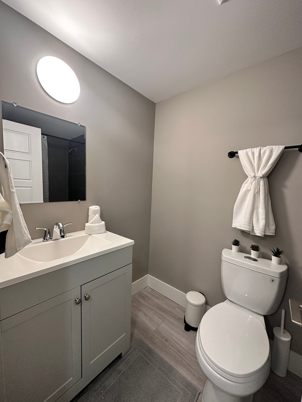 a small bathroom with a toilet sink and mirror