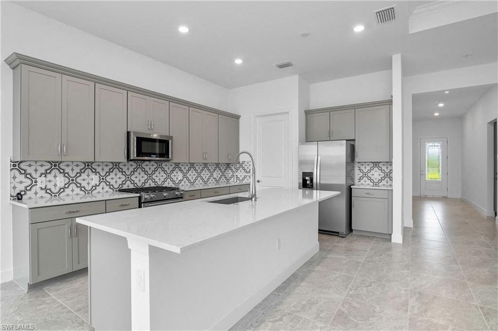 a large white kitchen with a large counter top