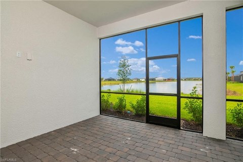 the living room of a house with large windows overlooking a lake