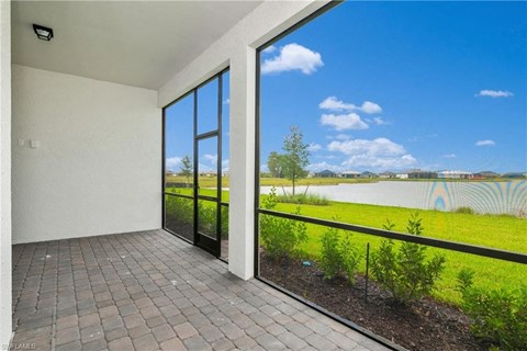 a view of the river from a balcony of a home with large windows