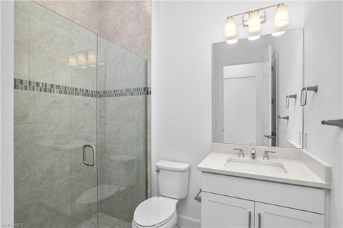 a bathroom with a sink toilet and a shower