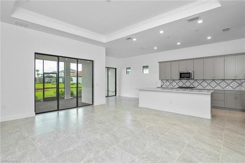 the kitchen is open to the living room and dining room