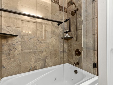a bathroom with a shower and a bath tub