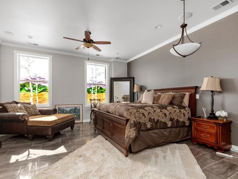 a bedroom with a bed and a ceiling fan