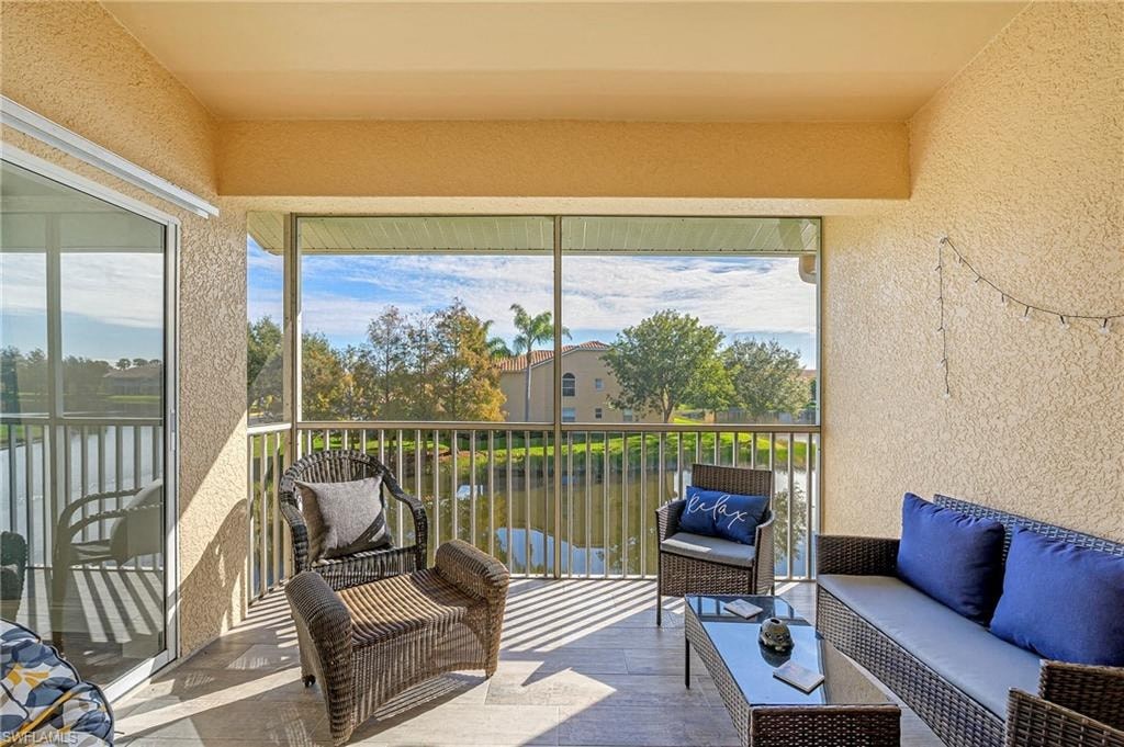 a living room with a couch and chairs on a balcony