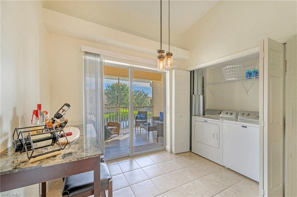 a kitchen with a washer and dryer and a door to a patio