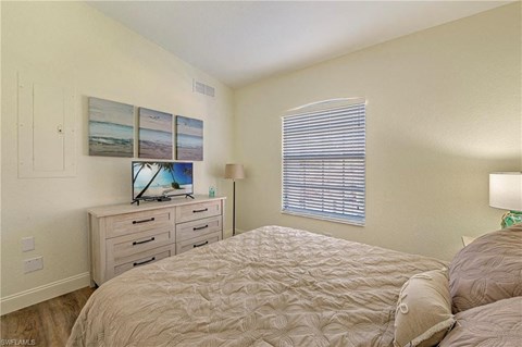 a bedroom with a bed and a dresser