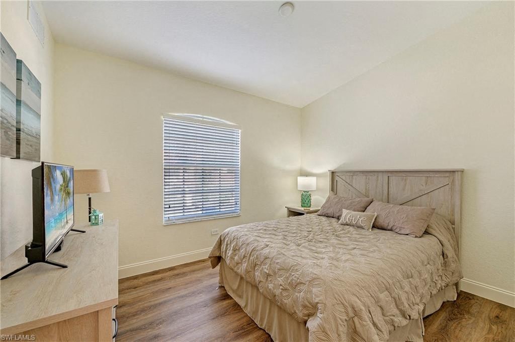 a bedroom with a bed and a tv