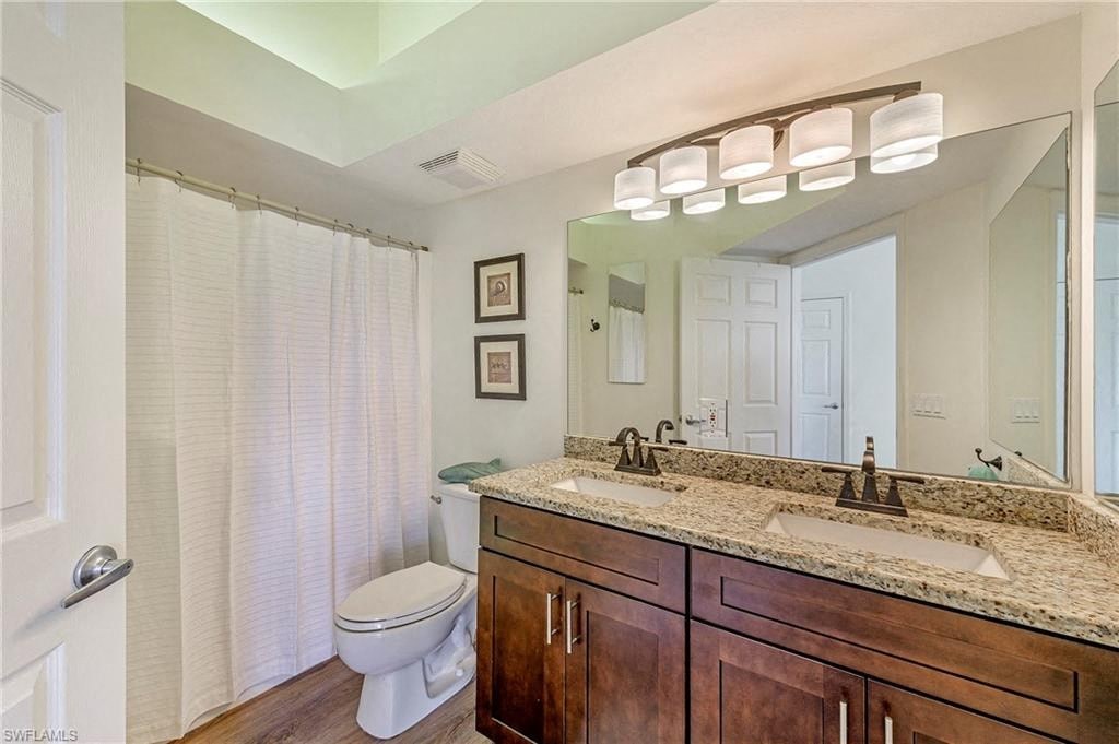 a bathroom with a sink and a toilet and a mirror