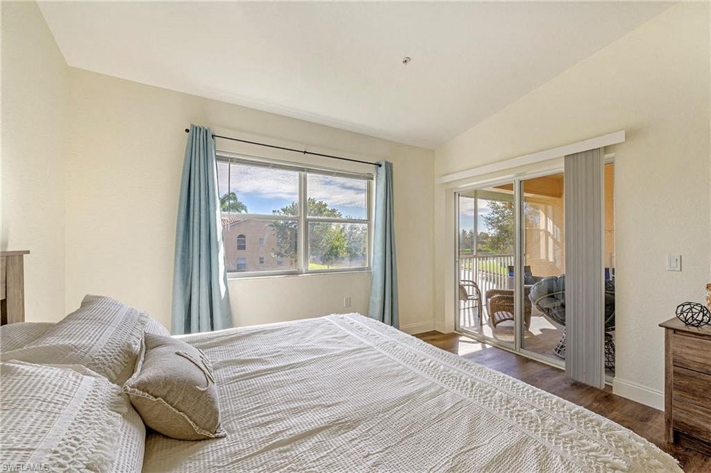 a bedroom with a bed and a sliding glass door to a balcony