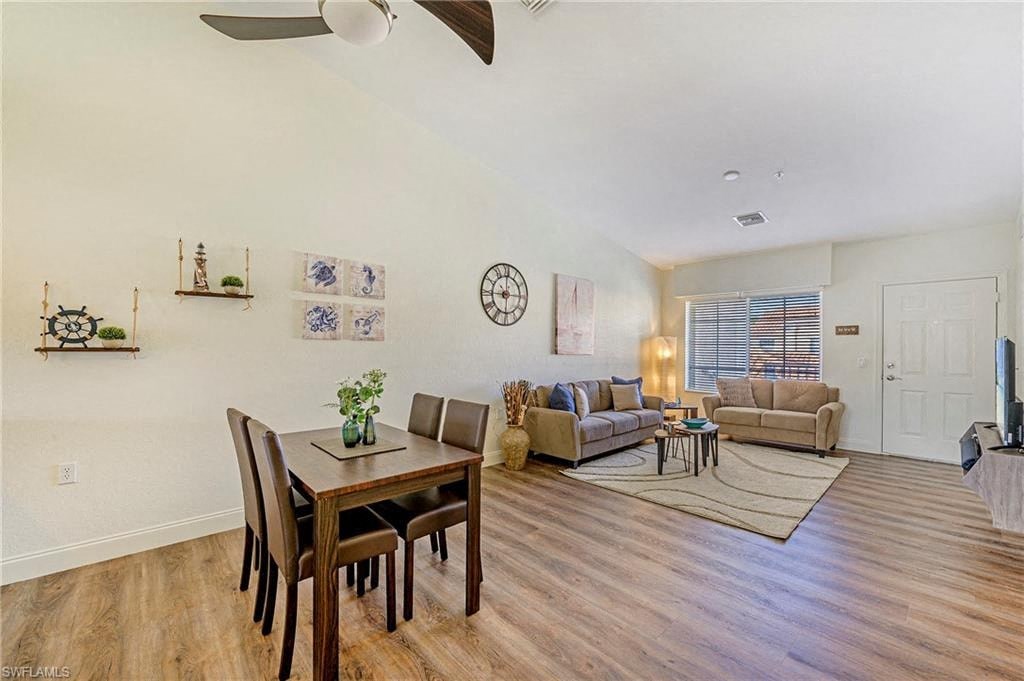 a living room and dining room with a table and chairs