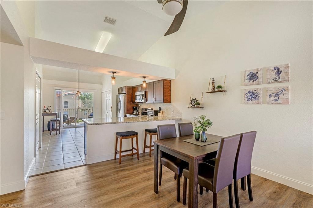 a dining room and kitchen with a table and chairs