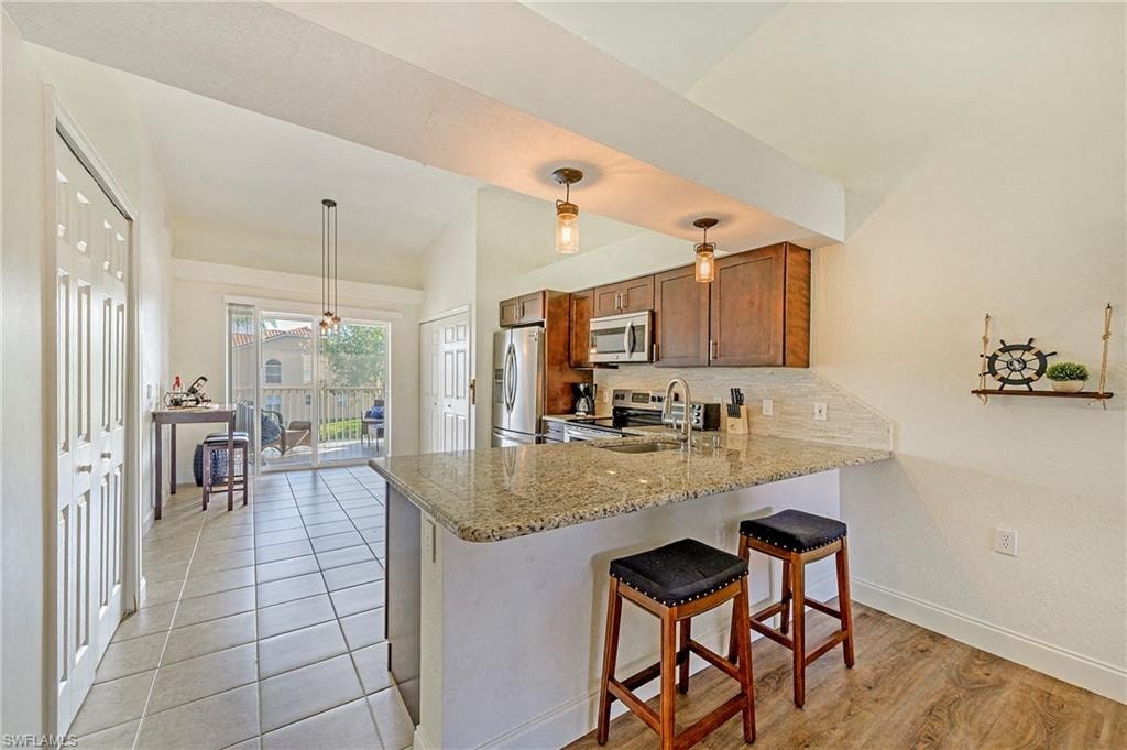 a kitchen with a marble counter top with three stools