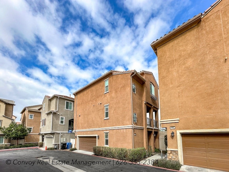 a group of brick apartment buildings with garage doors