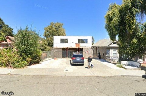a car parked in a driveway in front of a house