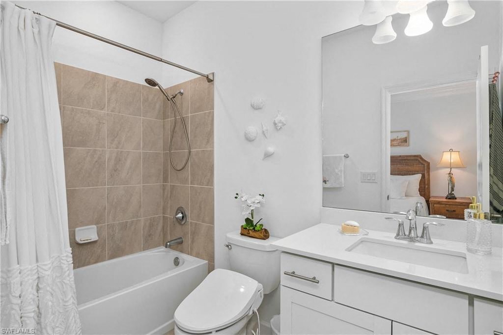 a bathroom with a tub sink toilet and a mirror