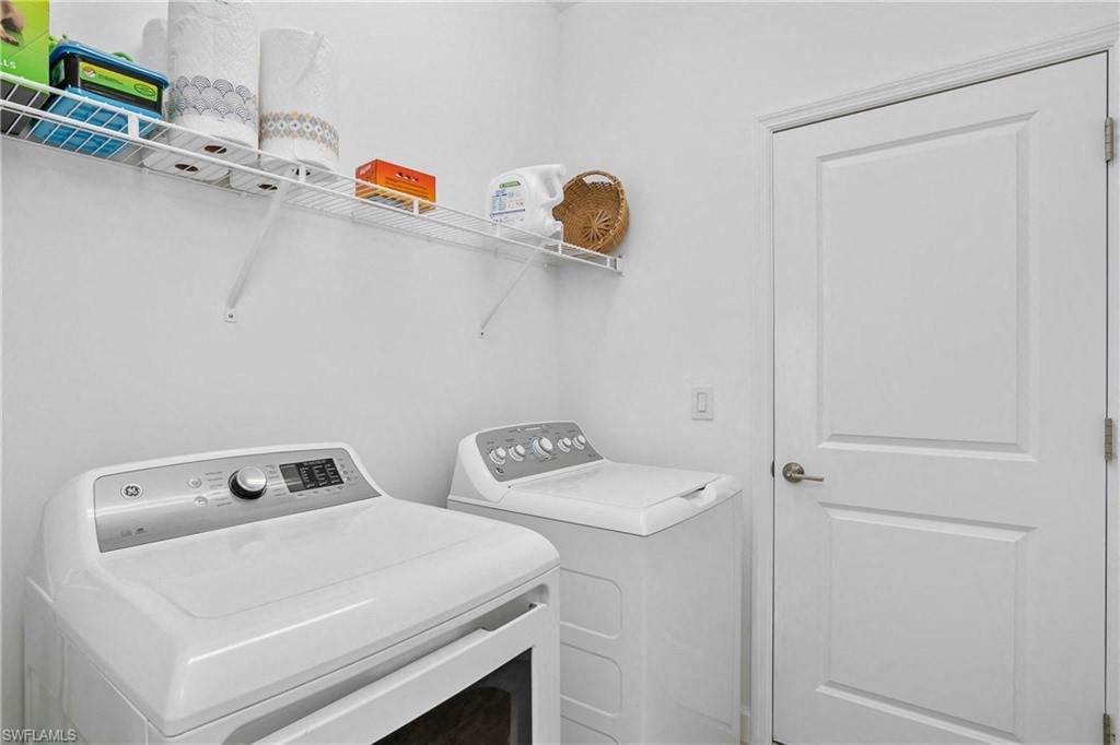 a white washer and dryer in a laundry room with a door