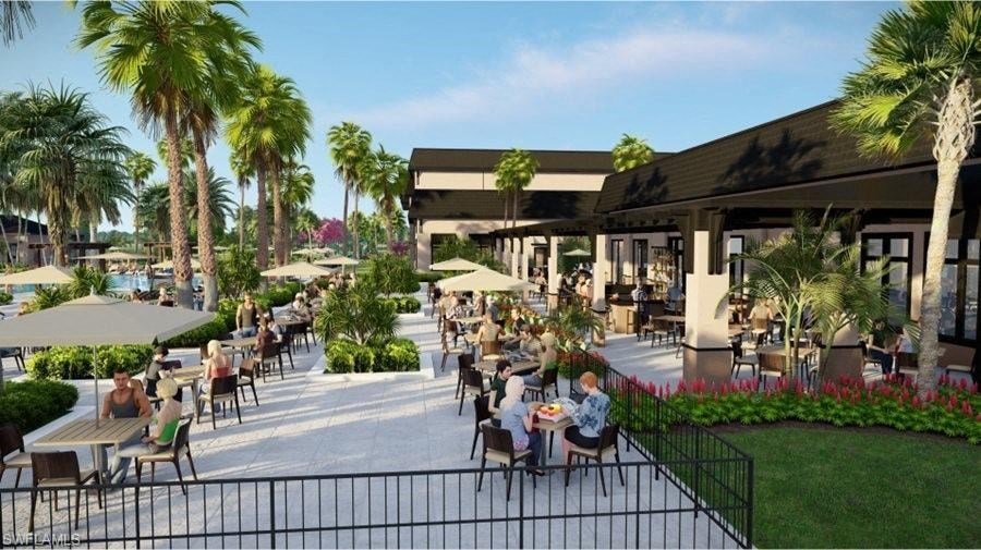 a group of people sitting at tables at an outdoor restaurant