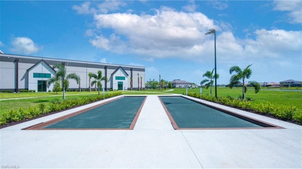 a tennis court with a building in the background
