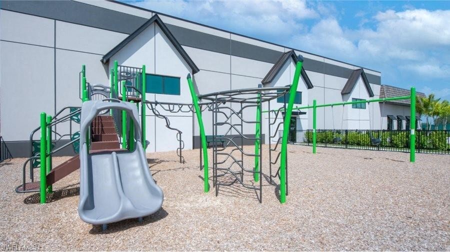 a playground with a swing set and a slide
