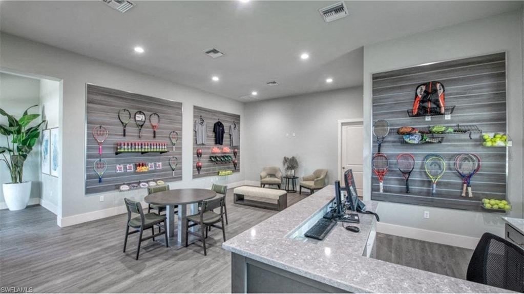 a living room with a kitchen and a table with chairs