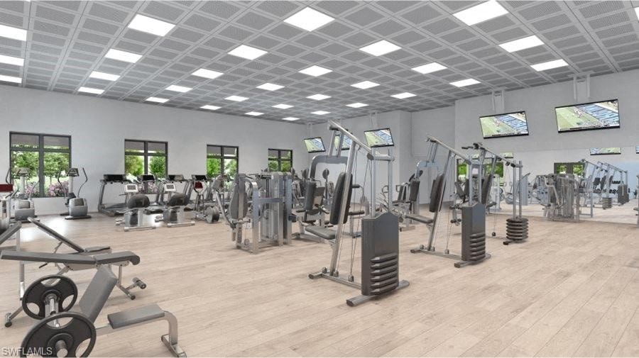 a gym with a lot of machines and weights in it