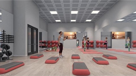 a group of people in a gym with exercise equipment