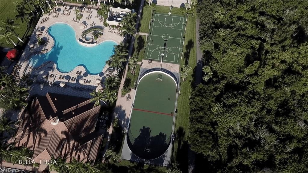 an aerial view of a tennis court and a swimming pool