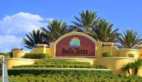 a sign for a bella terra resort in front of palm trees