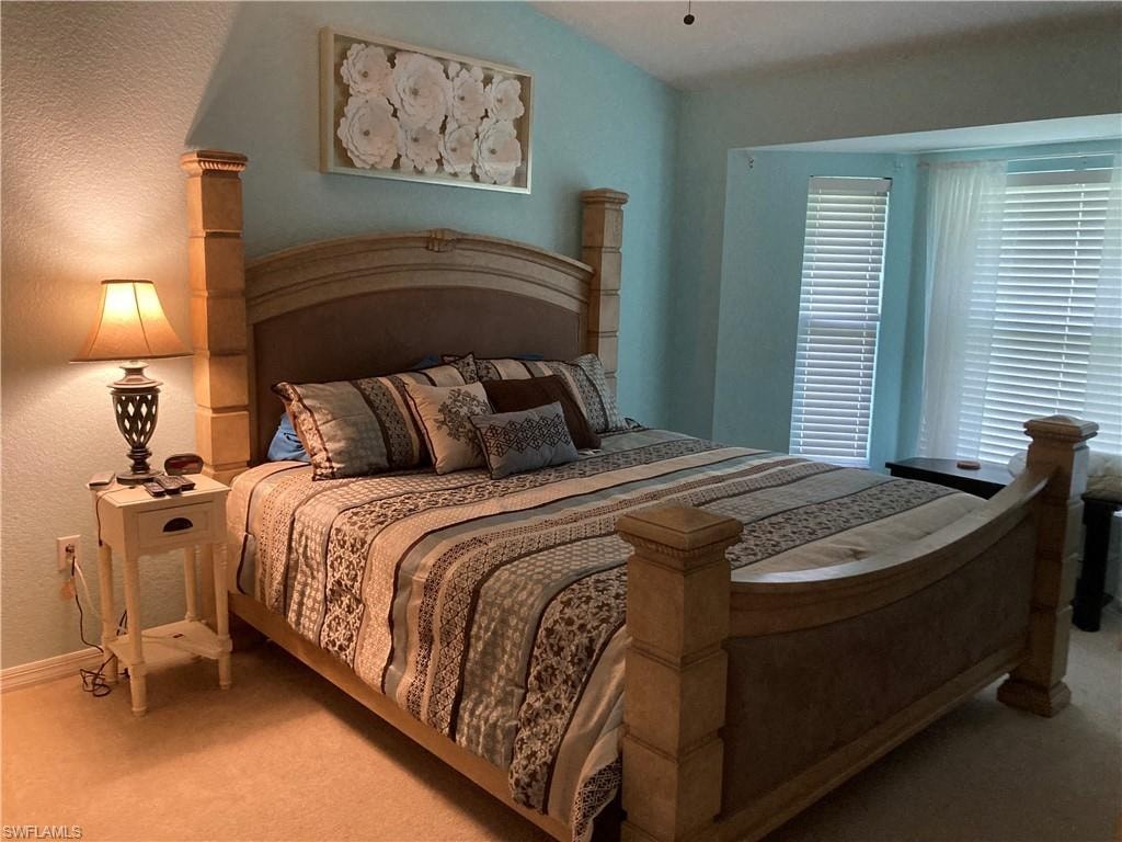 a bedroom with a bed and a night stand