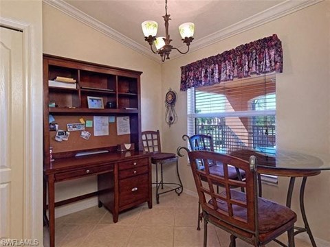 a dining room with a table and chairs