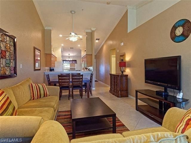 a living room and dining room with a television