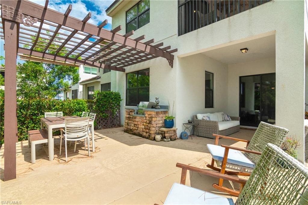 a patio with a table and chairs and a house