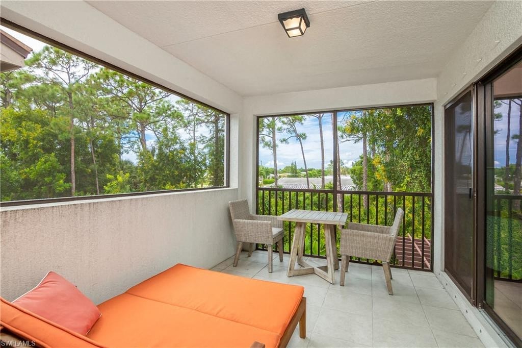 a room with a couch and a table on a balcony