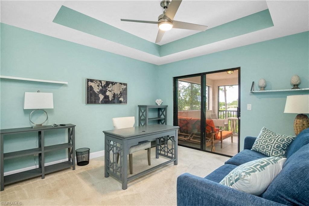 a living room with a couch and a desk