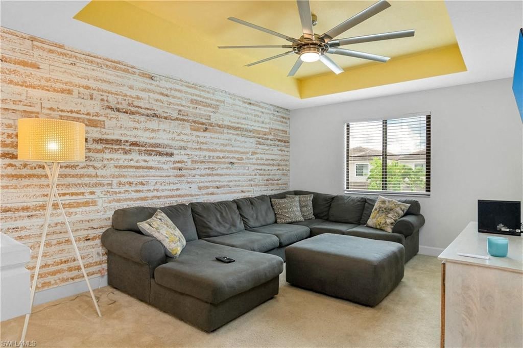 a living room with a couch and a ceiling fan