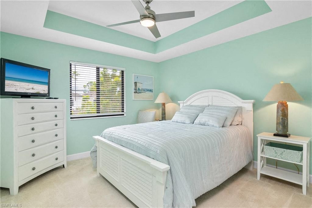 a bedroom with a bed and a ceiling fan