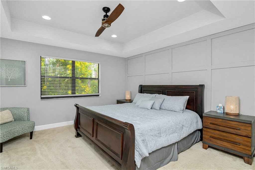 the master bedroom has a large bed and a window