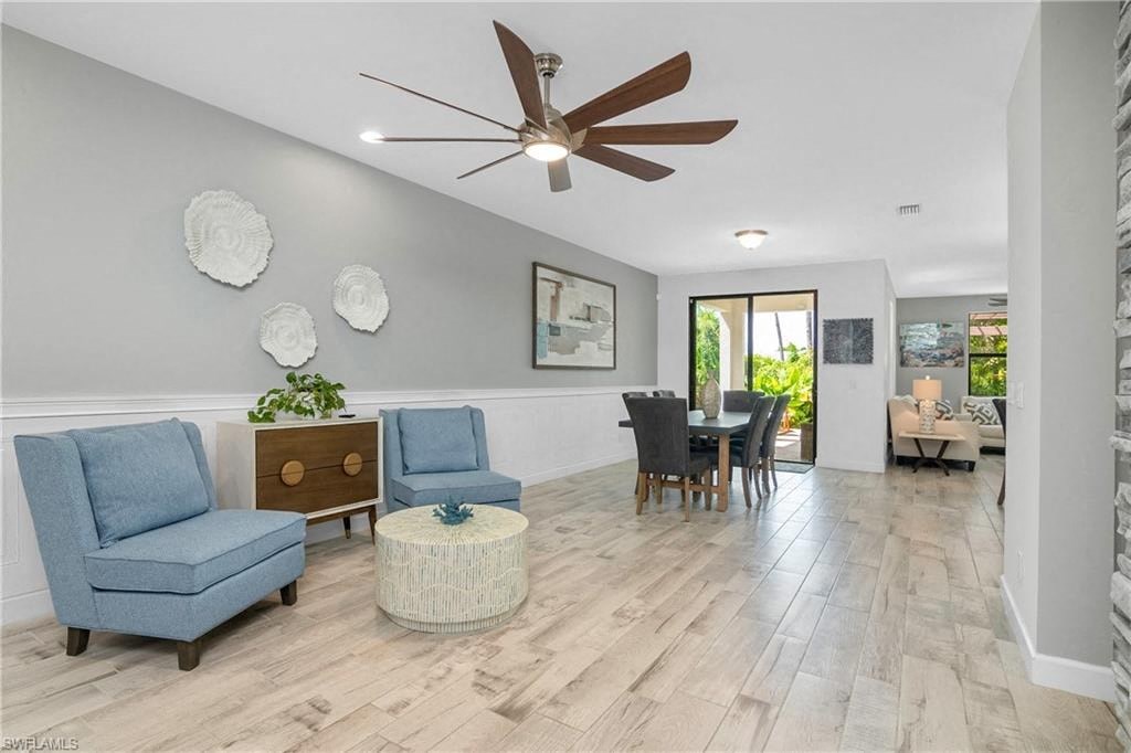 a living room and dining room with a ceiling fan