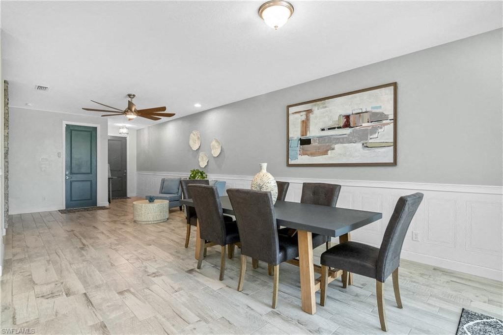a dining room with a table and chairs and a ceiling fan