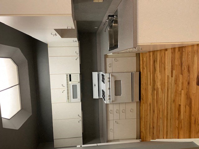 a kitchen with a wood wall and a door